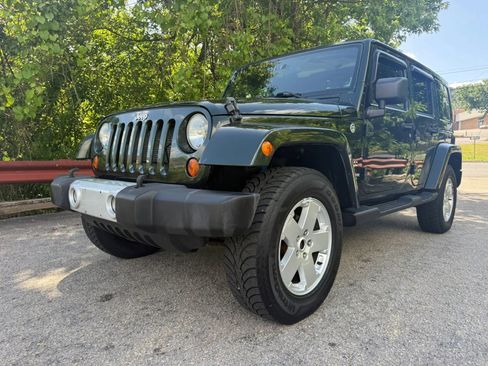 Used 2012 Jeep Wrangler Unlimited Sahara w/ Dual Top Group AWD/4WD image 1