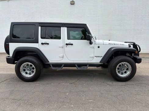 Used 2011 Jeep Wrangler Unlimited Rubicon w/ Dual Top Group AWD/4WD image 1