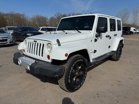 Used 2013 Jeep Wrangler Unlimited Sahara w/ Dual Top Group AWD/4WD image 1