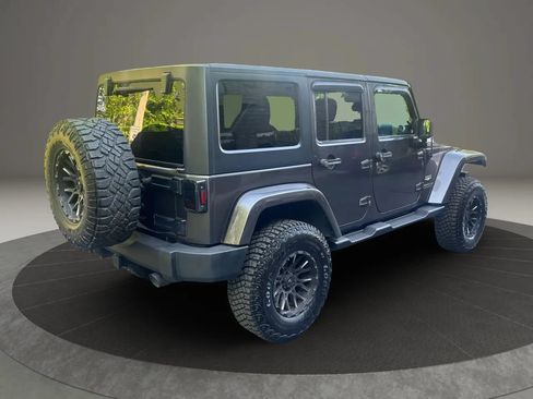 Used 2014 Jeep Wrangler Unlimited Sahara w/ Dual Top Group AWD/4WD image 11