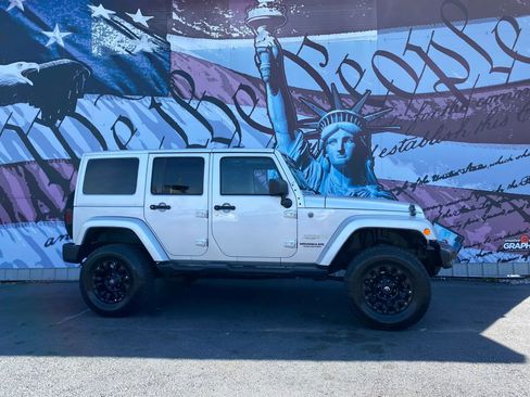 Used 2012 Jeep Wrangler Unlimited Sahara w/ Dual Top Group AWD/4WD image 1