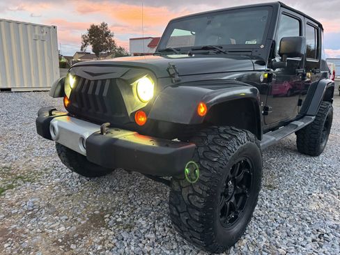Used 2012 Jeep Wrangler Unlimited Sahara w/ Dual Top Group AWD/4WD image 1