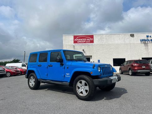 Used 2012 Jeep Wrangler Unlimited Sahara w/ Dual Top Group AWD/4WD image 1