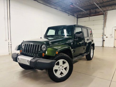 Used 2011 Jeep Wrangler Unlimited Sahara w/ Dual Top Group AWD/4WD image 1