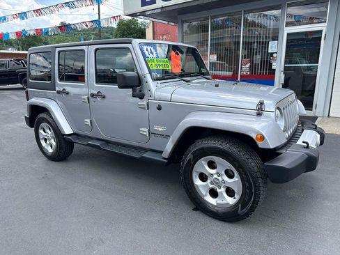 Used 2014 Jeep Wrangler Unlimited Sahara w/ Dual Top Group AWD/4WD image 1