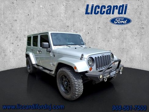 Used 2012 Jeep Wrangler Unlimited Sahara w/ Dual Top Group AWD/4WD image 1