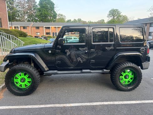 Used 2014 Jeep Wrangler Unlimited Sahara AWD/4WD image 1