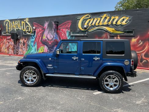 Used 2010 Jeep Wrangler Unlimited Sahara w/ Dual Top Group AWD/4WD image 1