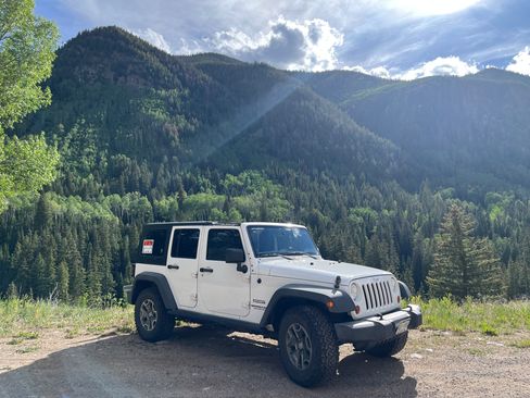 Used 2013 Jeep Wrangler Unlimited Sport w/ Mopar Black Appearance Group AWD/4WD image 1