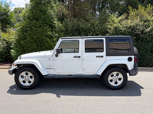 Used 2013 Jeep Wrangler Unlimited Sahara w/ Dual Top Group AWD/4WD image 1